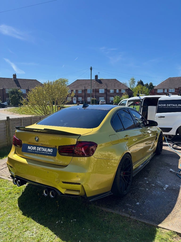 Austin Yellow BMW M3 detailed to a flawless gloss, rear three-quarter view