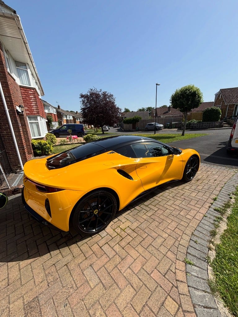 Yellow Lotus Emira side profile showing a deep, even gloss finish