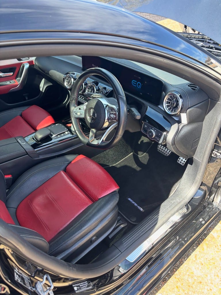 Mercedes-AMG A-Class red and black interior with dirty mats before detailing