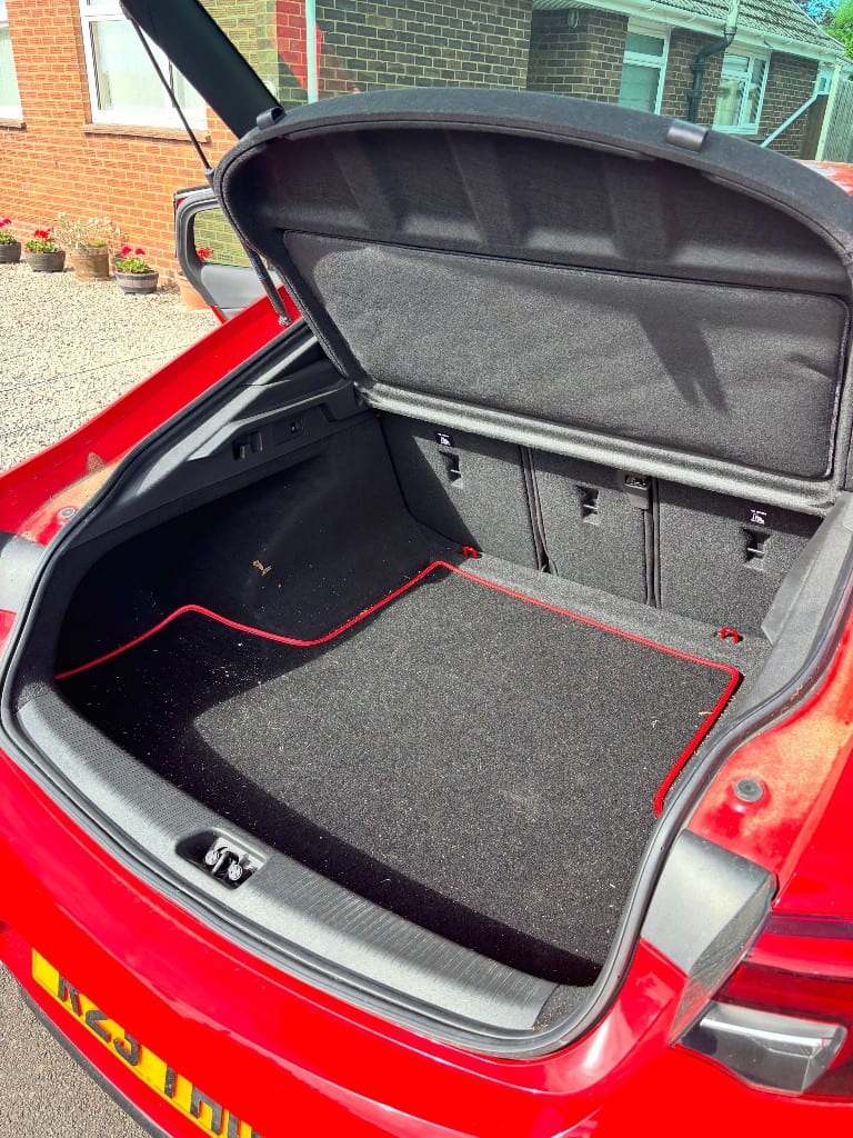 Car boot with dust and debris before cleaning
