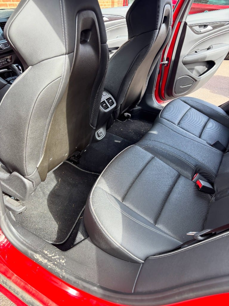 Rear seats and footwell dusty and dirty before an interior detail