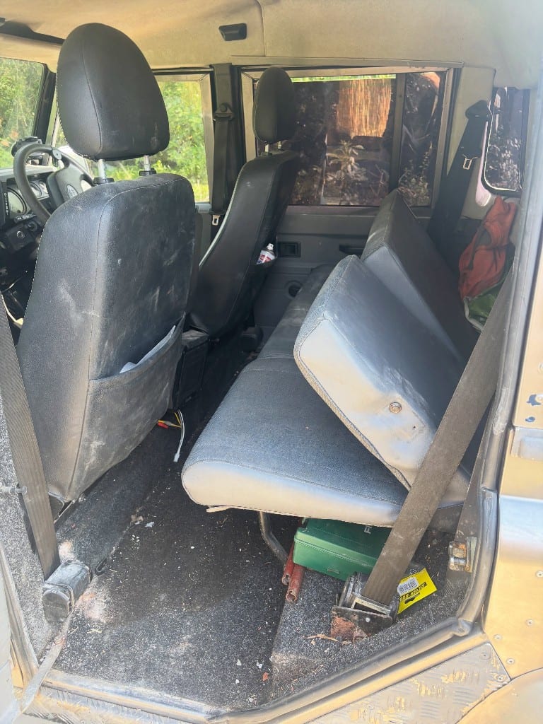 Muddy, dusty Land Rover Defender interior before cleaning