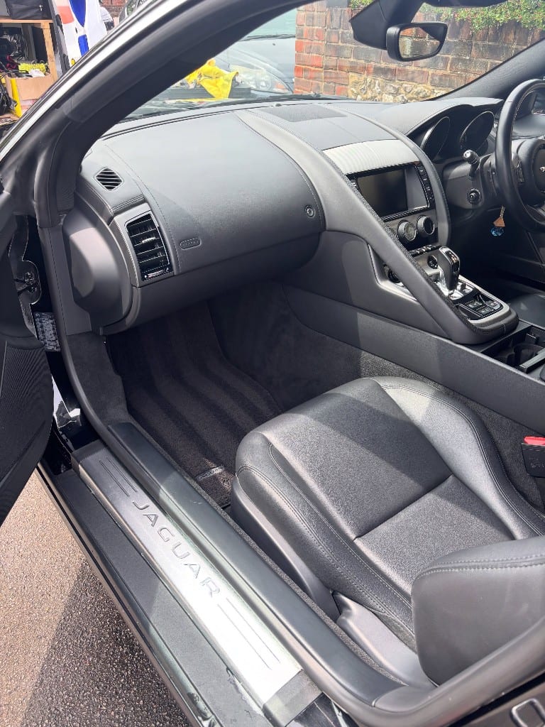 Jaguar F-Type interior with deep-cleaned carpets and trim after detailing