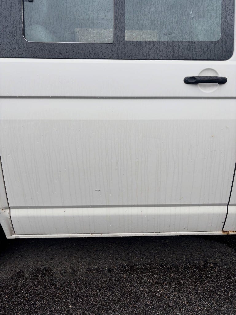 White VW Transporter side panel streaked with dirt and fallout before decontamination
