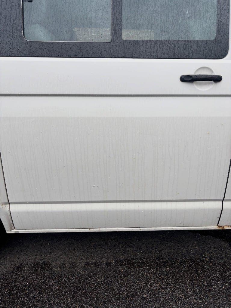 White VW Transporter side panel streaked with dirt and fallout before decontamination
