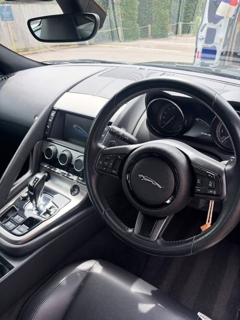 Jaguar F-Type cockpit deep cleaned with Noir Detailing van visible outside